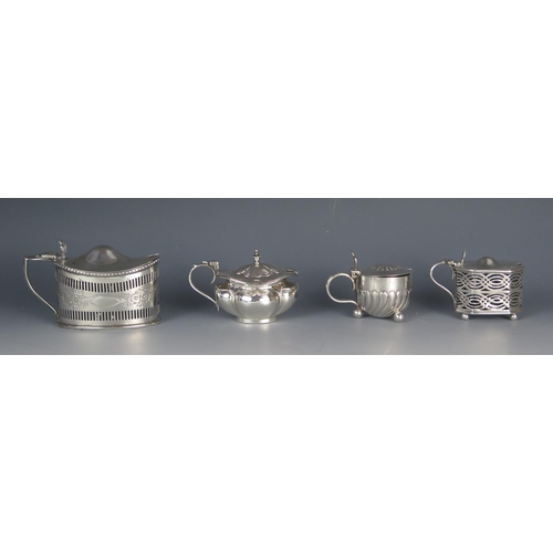 534 - Four assorted silver mustard pots and covers, various makers and dates, all with blue glass liners, ... 