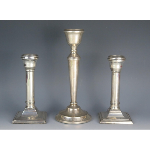 553 - A pair of George III silver candlesticks, maker's marks worn possibly B&C, Birmingham, 1923, with pl... 