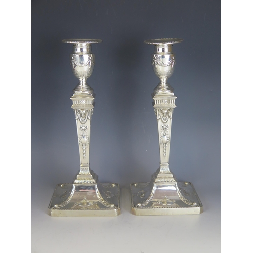 561 - A pair of late Victorian silver candlesticks, maker Hawksworth, Eyre & Co Ltd, Sheffield, 1897, with... 