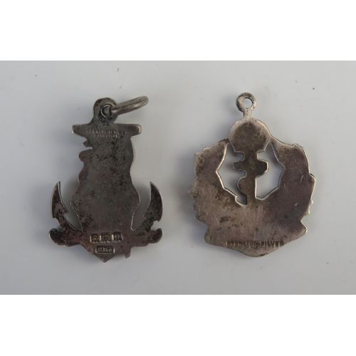 695 - Two silver Royal Navy pendants with fouled anchor and enamel decoration.