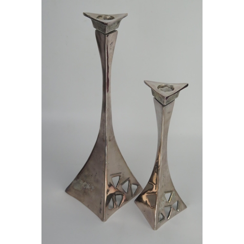 704 - Two matching modernist metal candlesticks of swept triangular form, with pierced decoration, 29cm an... 