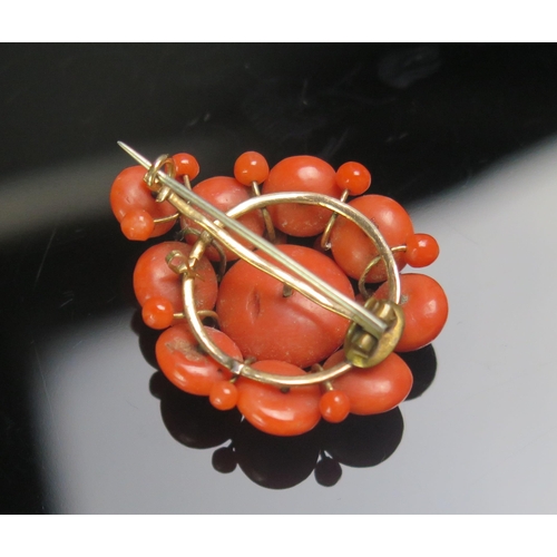 80 - An Antique Coral Brooch in a yellow metal mount, 34.3mm drop, 8.44g