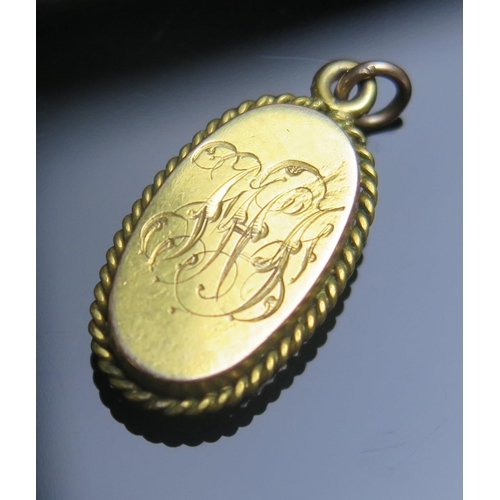 92 - A Victorian Peg Doll Locket in a precious yellow metal setting,  the carved wooden doll hinged at th... 