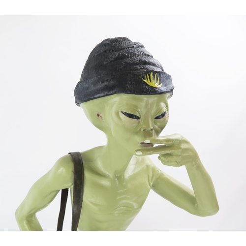 1034 - Life Size Alien Resin Figure with shoulder bag and hat decorated with yellow hemp, figures held to m... 