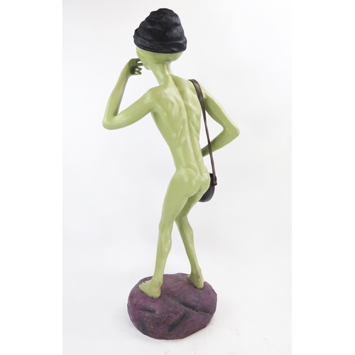 1034 - Life Size Alien Resin Figure with shoulder bag and hat decorated with yellow hemp, figures held to m... 