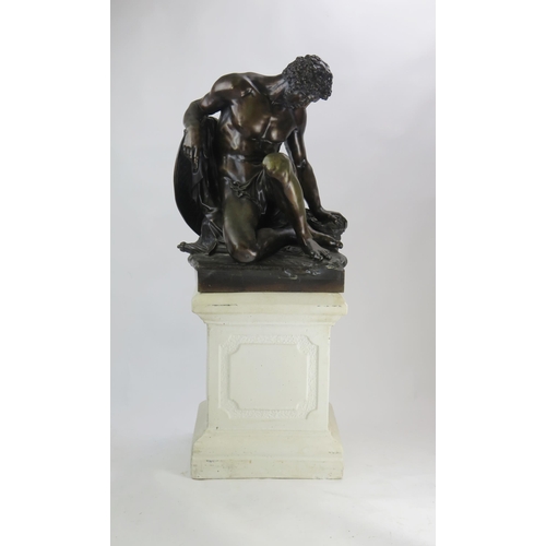After Pierre Julien (1731 - 1804) a large bronze study, The Dying Gaul, the wounded figure collapsed against an oval shield, on a naturalistic base, unsigned. raised on a reconstituted square plinth with moulded decoration. height of bronze 62cm overall height 107cm.