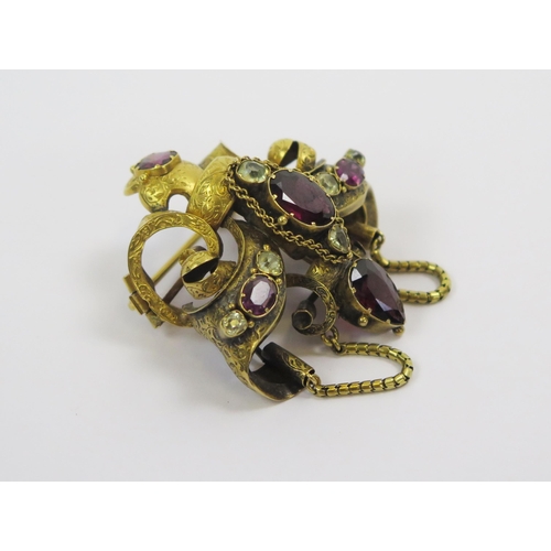 19 - A Victorian Precious Yellow Metal and Stone Set Brooch with chased scrolling decoration, c. 51.2mm d... 