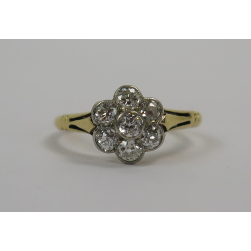 53 - An Antique 18ct Gold and Diamond 'Daisy' Cluster Ring, c.2.8mm old cut millegrain set stone, size K.... 