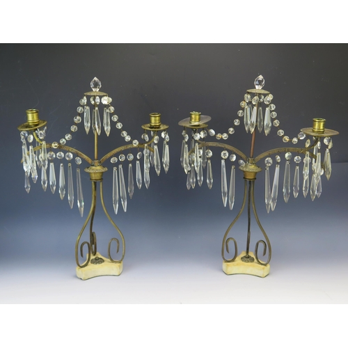 1282 - A pair of 19th century gilt metal twin branch candelabra, with glass prismatic suspensions, mounted ... 