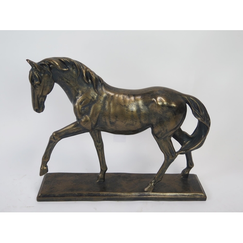 1291 - A bronzed resin model of a stallion, on a rectangular plinth base, 41cm long, 34cm high.