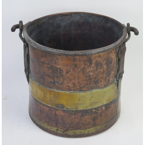 1292 - A 19th century brass and copper log bin of cylindrical form, with steel loop handle, 35cm high, 36cm... 