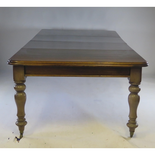 1513 - A Victorian mahogany extending dining table, the rectangular top with a moulded edge raised on turne... 