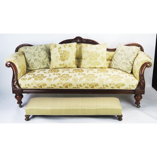 1588 - A Victorian Carved Mahogany upholstered three seater Settee, with scroll ends, 208cm with footstool