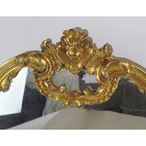 1593A - A 20th century giltwood overmantel of arched outline, with scroll and foliate cresting, 116cm x 136c... 