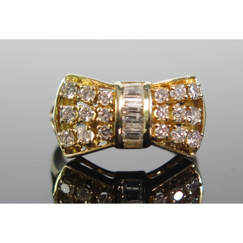 103 - An 18K Gold and Diamond Bow Ring, set with .93cts of brilliant round and baguette cut stones, size L... 