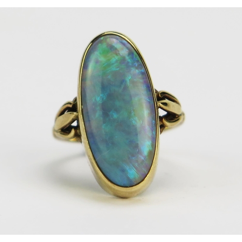 11 - A 9ct Gold and Opal Dress Ring displaying a good range of greens and blues, c. 19.3x8.6mm rub over s... 