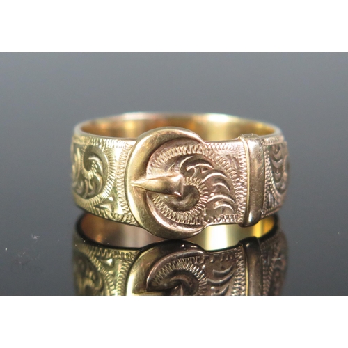 110 - A 9ct Gold Buckle Ring with chased foliate scroll decoration, 11.4mm wide buckle, size U.5, stamped ... 