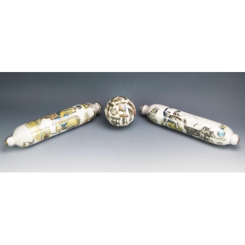 1116 - Two clear glass and decoupage decorated rolling pins, 36cm long together with a matching ball. (3).