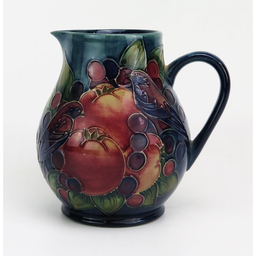 1121 - A contemporary Moorcroft pottery jug in the Finches and Fruit pattern, of bulbous form, with printed... 