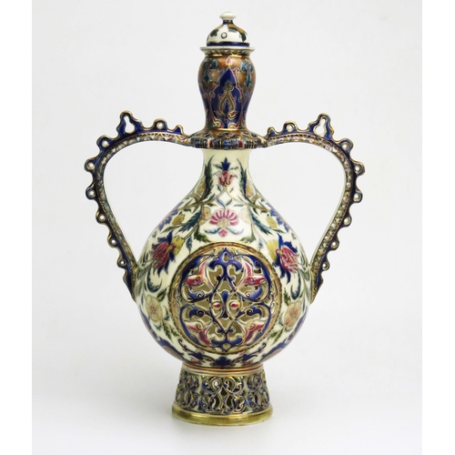 1128 - A Zsolnay Pecs twin-handled vase and cover, of ovoid outline, with domed cover, swept handles, the b... 