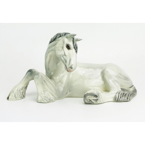 1130 - A Beswick dapple grey Shire mare lying down, gloss finish, 25cm long,