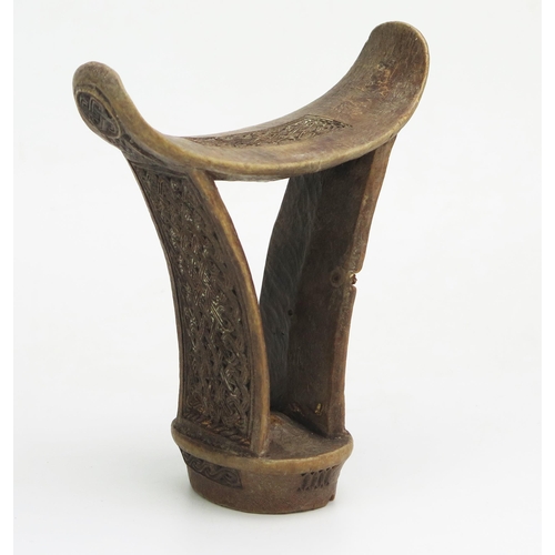 1146 - A Boni or Somali carved wood headrest, of traditional design, with entwined knotted carved panels.18... 