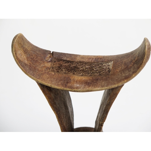 1146 - A Boni or Somali carved wood headrest, of traditional design, with entwined knotted carved panels.18... 