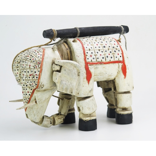 1147 - An Indian polychrome decorated wood elephant puppet, with hinged head, ears and legs. 34cm long.