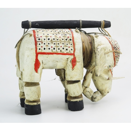 1147 - An Indian polychrome decorated wood elephant puppet, with hinged head, ears and legs. 34cm long.