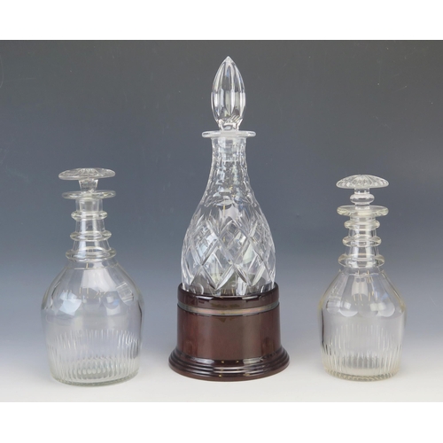 1153 - A 19th century glass decanter with triple ring neck and mallet shape, 23.5cm high, another similar d... 