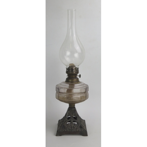 1159 - A Victorian Oil Lamp with a slice cut glass reservoir and on  a pierced cast iron base decorated wit... 