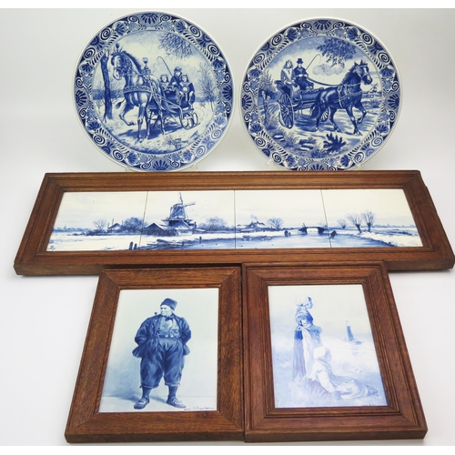 1165 - Two Delft tiles decorated with Dutch figure, mounted in oak frames, a set of four Dutch Delft scenic... 