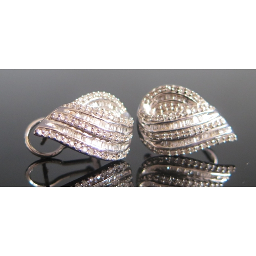 117 - A Pair of 9ct White Gold and Diamond Earrings set with brilliant round and baguette cuts, 19.7x13.5m... 