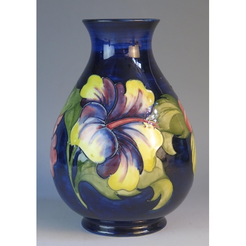 1188 - A Moorcroft pottery vase of ovoid form with Hibiscus pattern decoration, 22cm high.