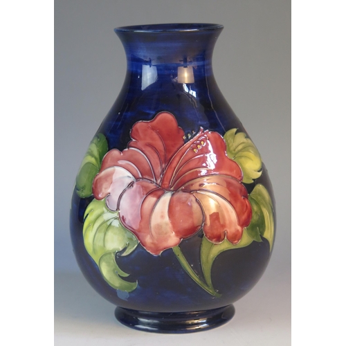 1188 - A Moorcroft pottery vase of ovoid form with Hibiscus pattern decoration, 22cm high.