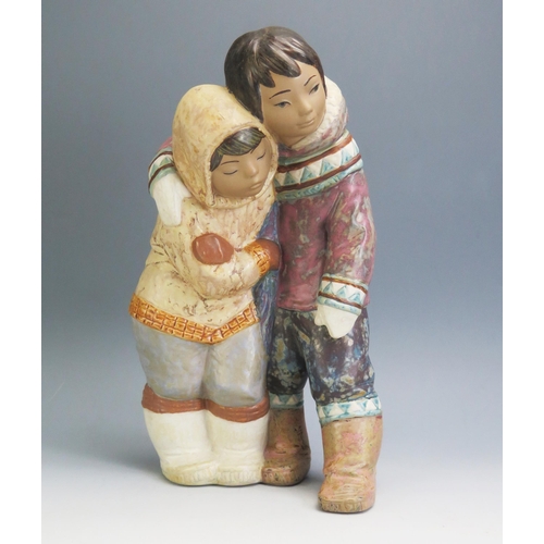 1190 - A large Lladro figure group of an Eskimo boy and girl, No. 2038 designed by Juan Huerta, 35cm high.