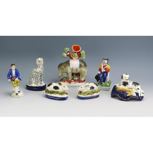 1193 - A mixed collection of Staffordshire and other ceramics including cat inkwell, elephant spill vase, s... 