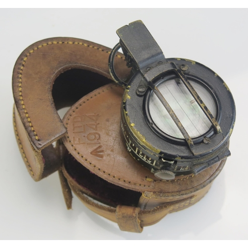 1204A - A British army issue hand held compass contained in its leather case.