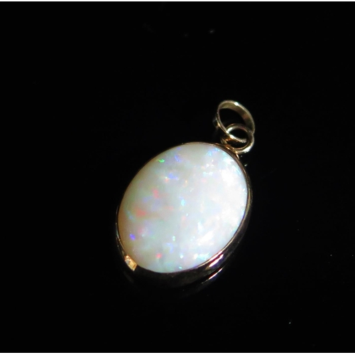 121 - A 9ct Gold and Opal Pendant, 24.3mm drop, hallmarked, 2.11g