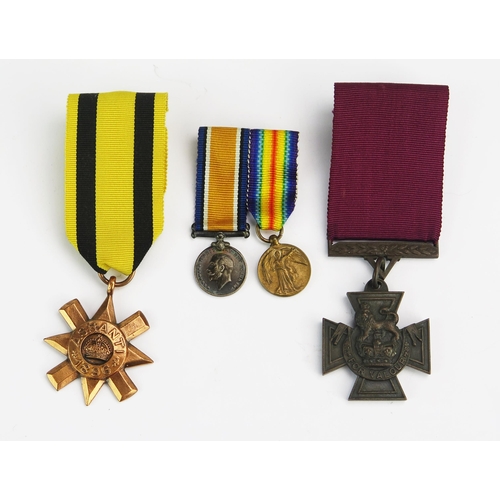 1215 - A replica Victoria Cross, replica Ashanti Star, and a miniature pair of World War One Medals.