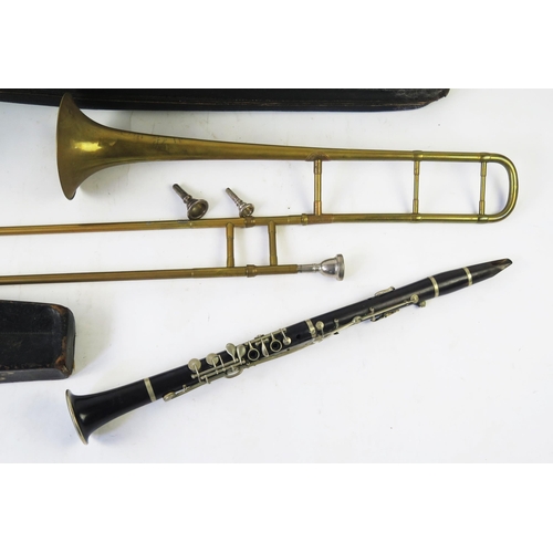 1221 - A Glaccroix Superior G F clarinet, contained in a stitched leather case, a brass trombone with spare... 