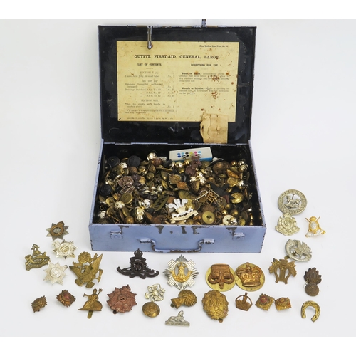 1222 - An extensive  collection of assorted army cap badges, buttons, contained in a British army First-Aid... 