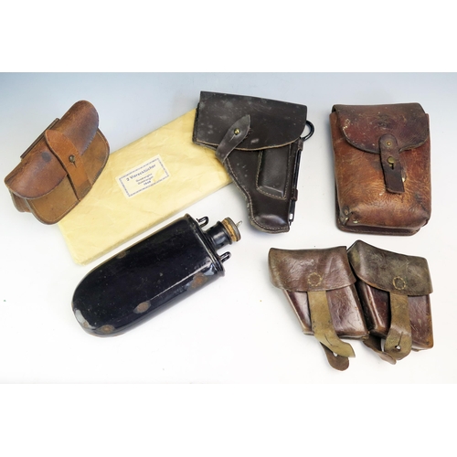 1245A - Three assorted leather ammunition pouches, pistol holster, field dressing together with a metal wate... 