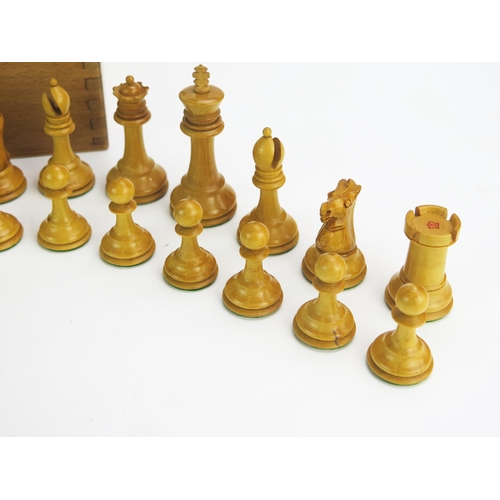 1257 - A 19th century boxwood Staunton pattern chess set one side left natural the other ebonised, the king... 