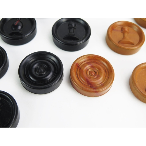 1259 - A Bakelite combination chess and draughts set, with brown and black discs, the chess pieces raised i... 