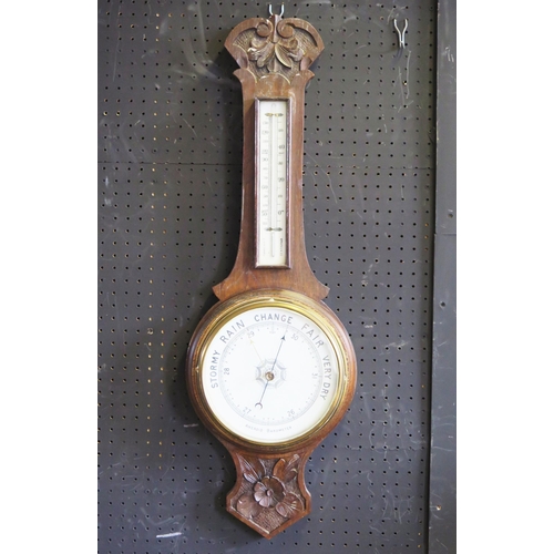 1267 - An Edwardian oak cased wheel barometer, or arched outline,  with mercurial thermometer, and aneroid ... 