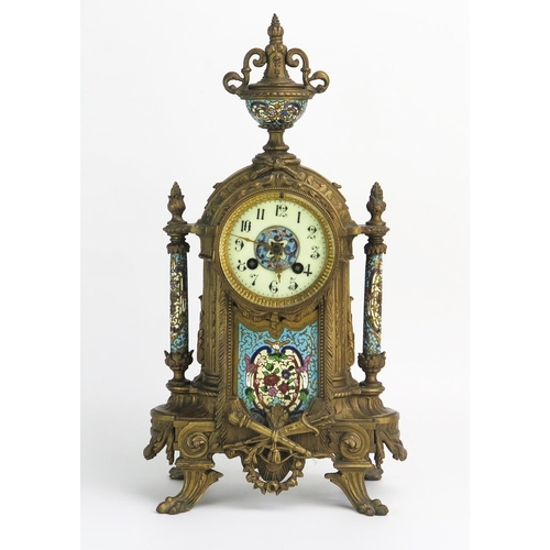 1268 - A late 19th century gilt metal and champlevé enamel mantel clock, of arched outline with urn finial,... 