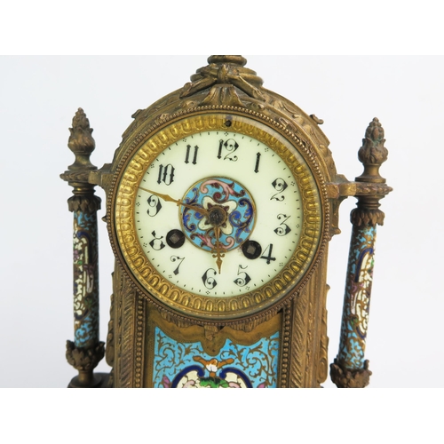 1268 - A late 19th century gilt metal and champlevé enamel mantel clock, of arched outline with urn finial,... 