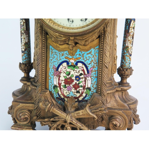 1268 - A late 19th century gilt metal and champlevé enamel mantel clock, of arched outline with urn finial,... 