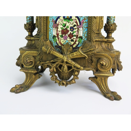 1268 - A late 19th century gilt metal and champlevé enamel mantel clock, of arched outline with urn finial,... 